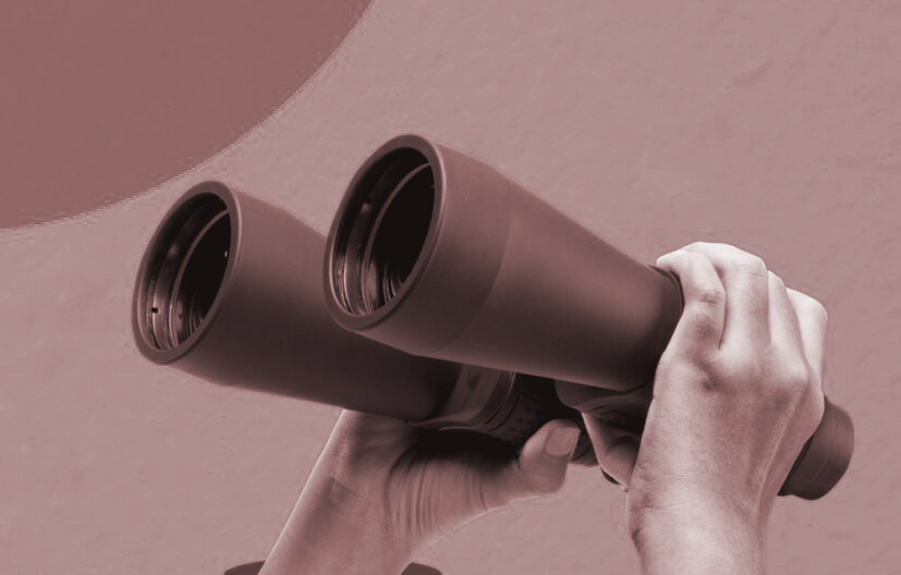 A human hand holding the binoculars on a colored background. Collage art
